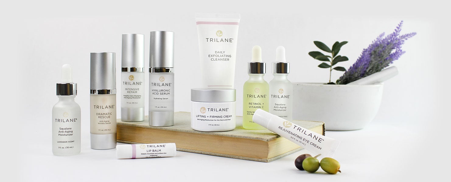 Trilane Skincare products with book and mortar pestle